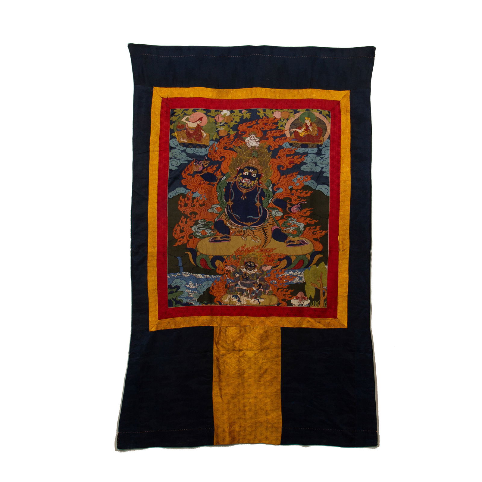 CHINESE YUNJIN BROCADE MAHAKALA THANGKA: Dimensions: L. 188 cm. W. 110 cm. This magnificent Chinese Yunjin (Nanjing brocade) thangka depicts the powerful Buddhist deity Mahakala at its center, rendered with intricate silk brocade
