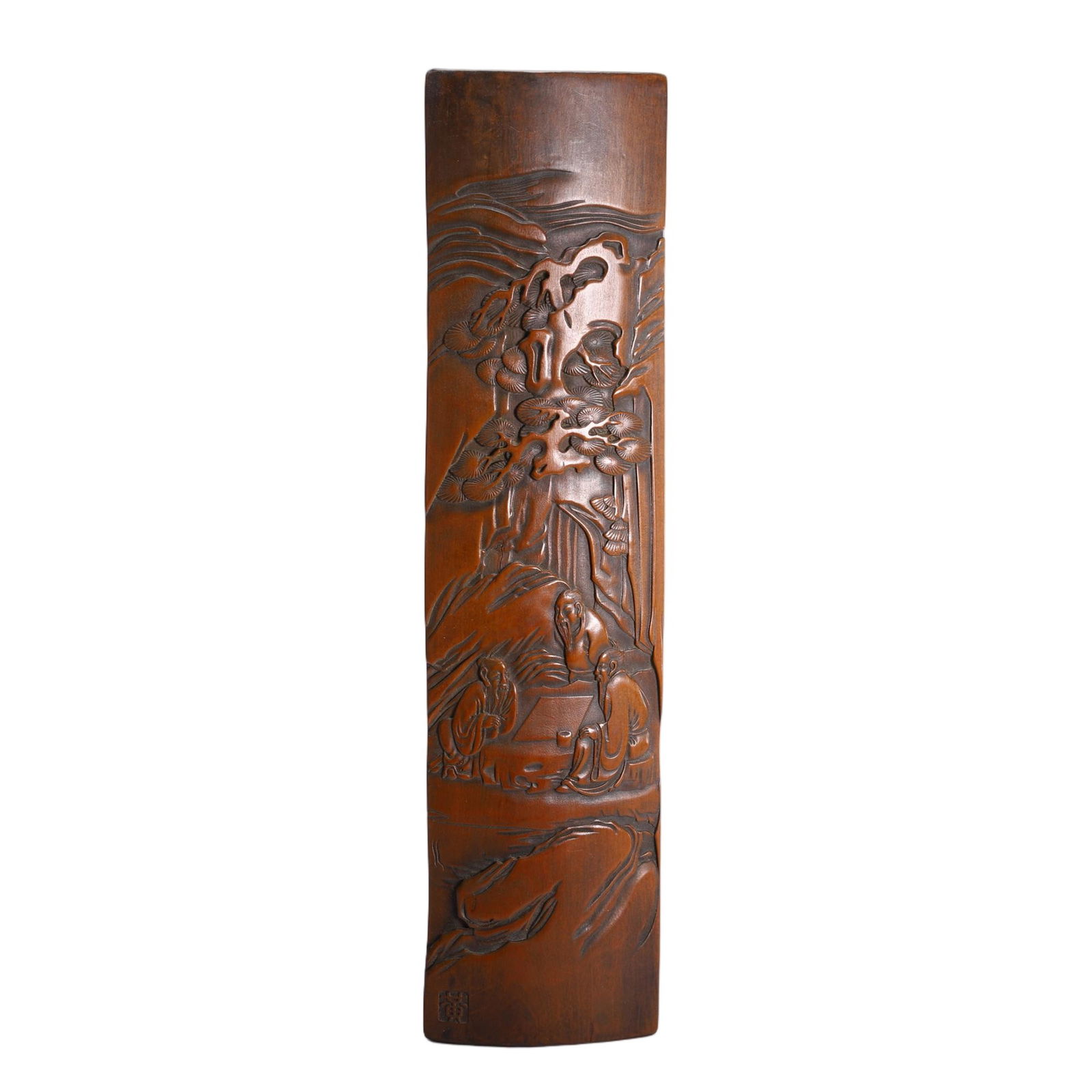 CHINESE BAMBOO CARVED WRIST REST: Dimensions: L. 25.5 cm. W. 6.5 cm. Weight 130 grams. This refined Chinese bamboo carved wrist rest features a high-relief landscape scene with scholars conversing beneath pine trees and cranes in