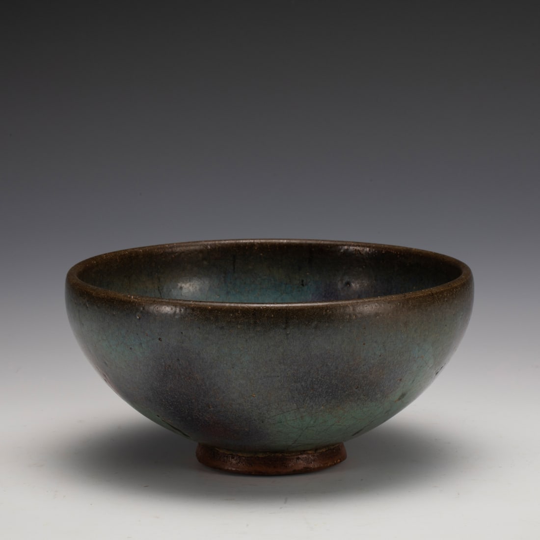 SONG JUN WARE LARGE BOWL: Measurements: Width: 17 cm, Height: 8.3 cm Chinese Song Jun Ware Porcelain Bowl. The porcelain potted in a shallow, slight deep, flaring rim with close mouth rim, raised on ring foot base. Jun ware