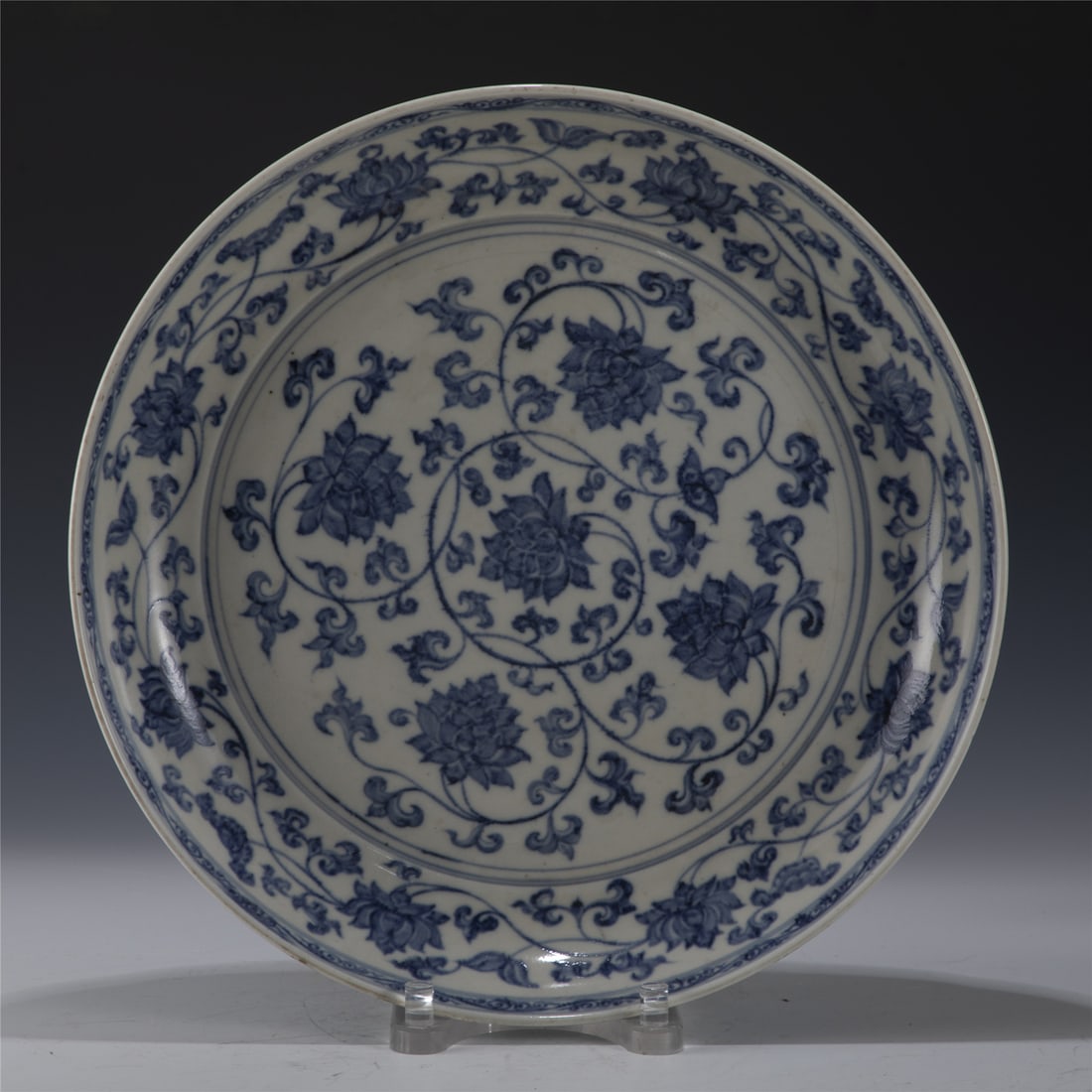 MING BLUE & WHITE LOTUS PLATE: Measurements: Length: 49.2cm, Width: 49.2cm, Height: 7.4cm Chinese Ming Dynasty Blue and White Lotus Porcelain Plate. The plate has a broad wide central interior, rounded mouth lip, thick and