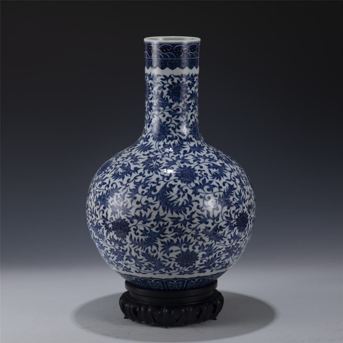 YONGZHENG BLUE & WHITE CELESTIAL VASE ON STAND: Measurements: Length: 30.5cm, Width: 30.5cm, Height: 43cm Chinese Qing Dynasty YongZheng Blue and White Lotus Porcelain Celestial Vase On Carved Hardwood Stand. Potted in celestial shape vase, thick a