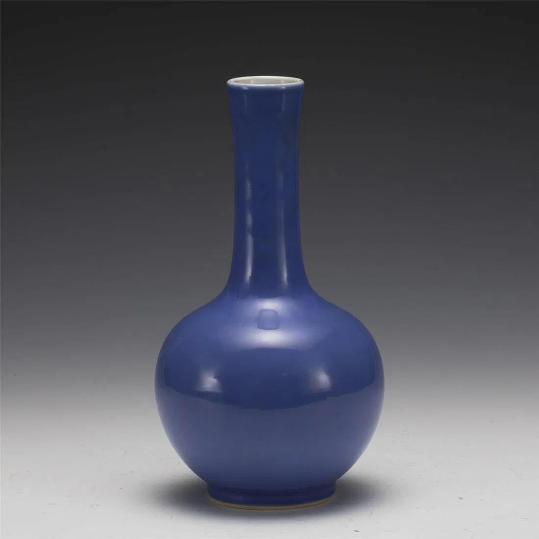 QING YONGZHENG BLUE GLAZED BOTTLE: Measurements: Length: 13 cm, Height: 24 cm Chinese Qing Dynasty Yongzheng Blue Glazed Porcelain Bottle Vase. Potted in shape vase, thick and tall, globular lower body, cylindrical neck, close mouth ri