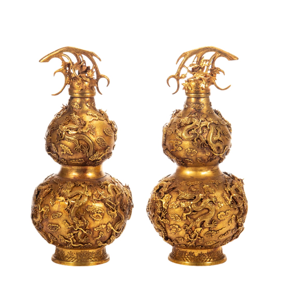 CHINESE GILT BRONZE GOURD VASE PAIR: Dimensions: L. 17 cm. H. 35 cm. Weight 4950 grams. This exquisite pair of Chinese gilt bronze double-gourd (hulu) vases features high-relief carvings of writhing dragons amid cloud scrolls across the