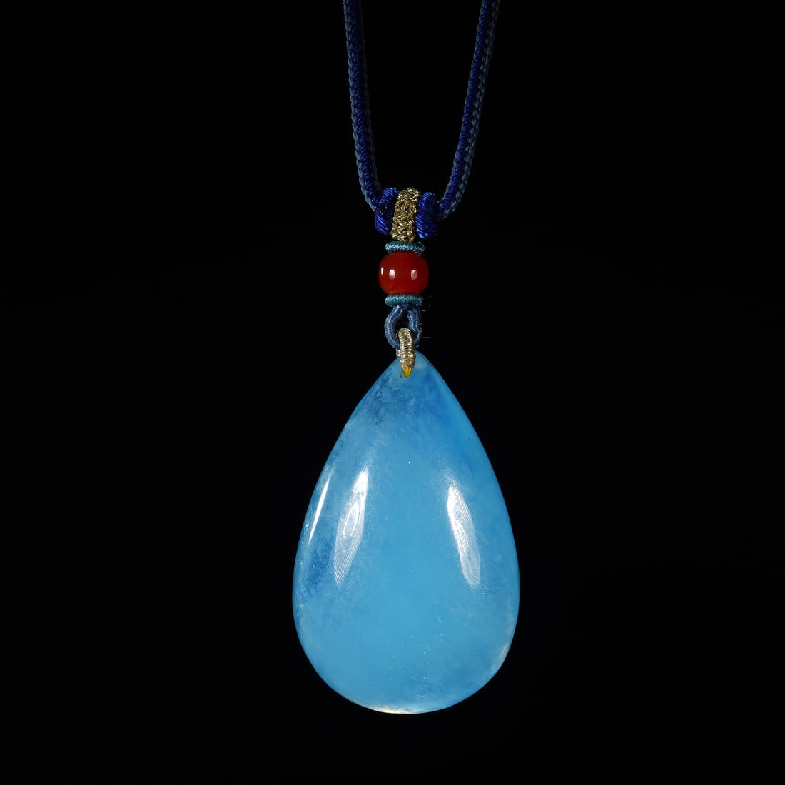 CHINESE AQUAMARINE TEARDROP PENDANT: Dimensions: 3.8x2x6cm cm. Weight 66 grams. A fine Chinese aquamarine teardrop pendant, carved from a single piece of vibrant sky-blue aquamarine with natural subtle inclusions and a glossy polished fi