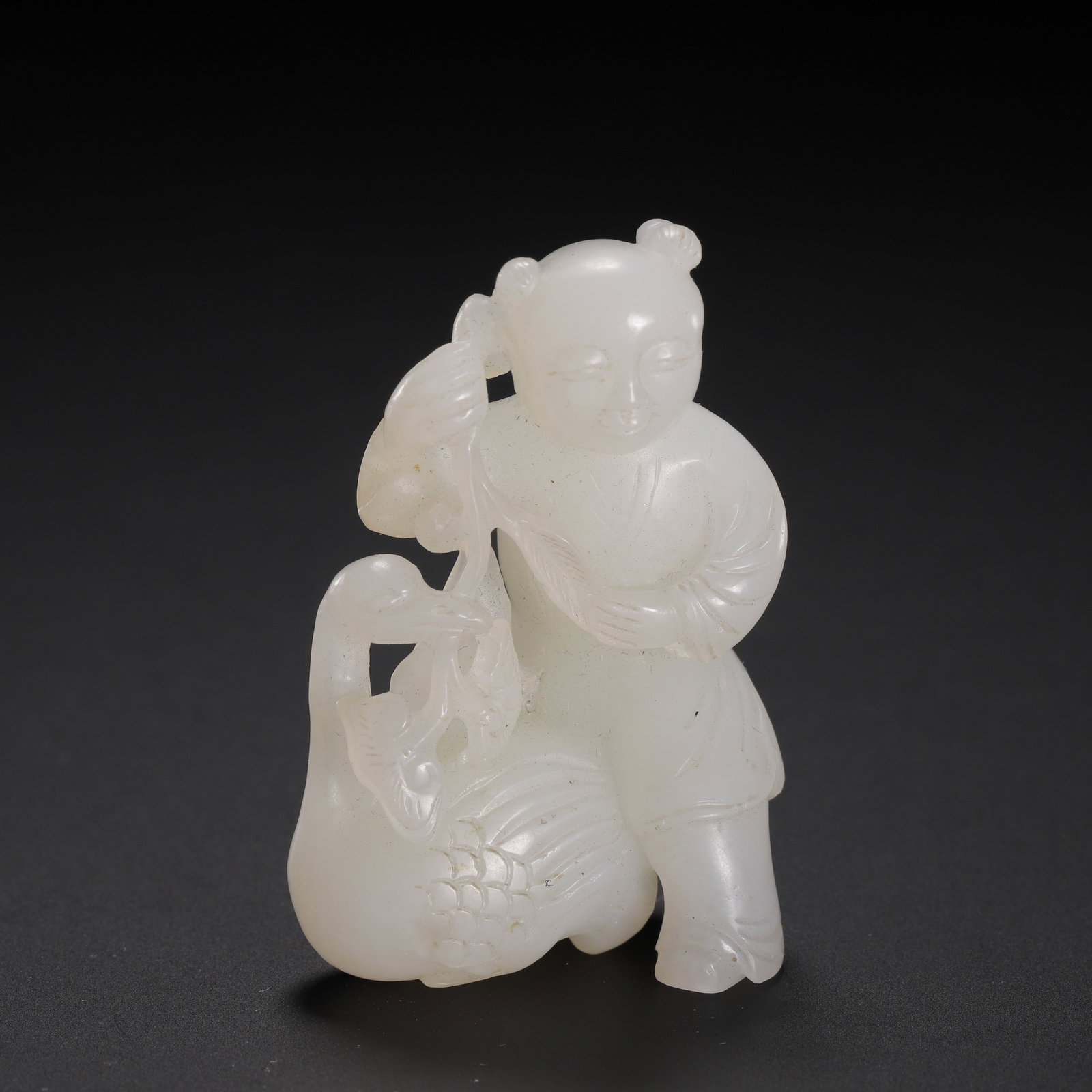 A CHINESE HETIAN JADE BOY & GOOSE PENDANT: Dimensions: H. 4.5 cm. This is an exquisite Chinese Hetian jade pendant, carved in the motif of "Xi Zhi Loves the Goose" (Xi Zhi Ai E), standing 4.5 cm tall. The piece is meticulously carved from a si