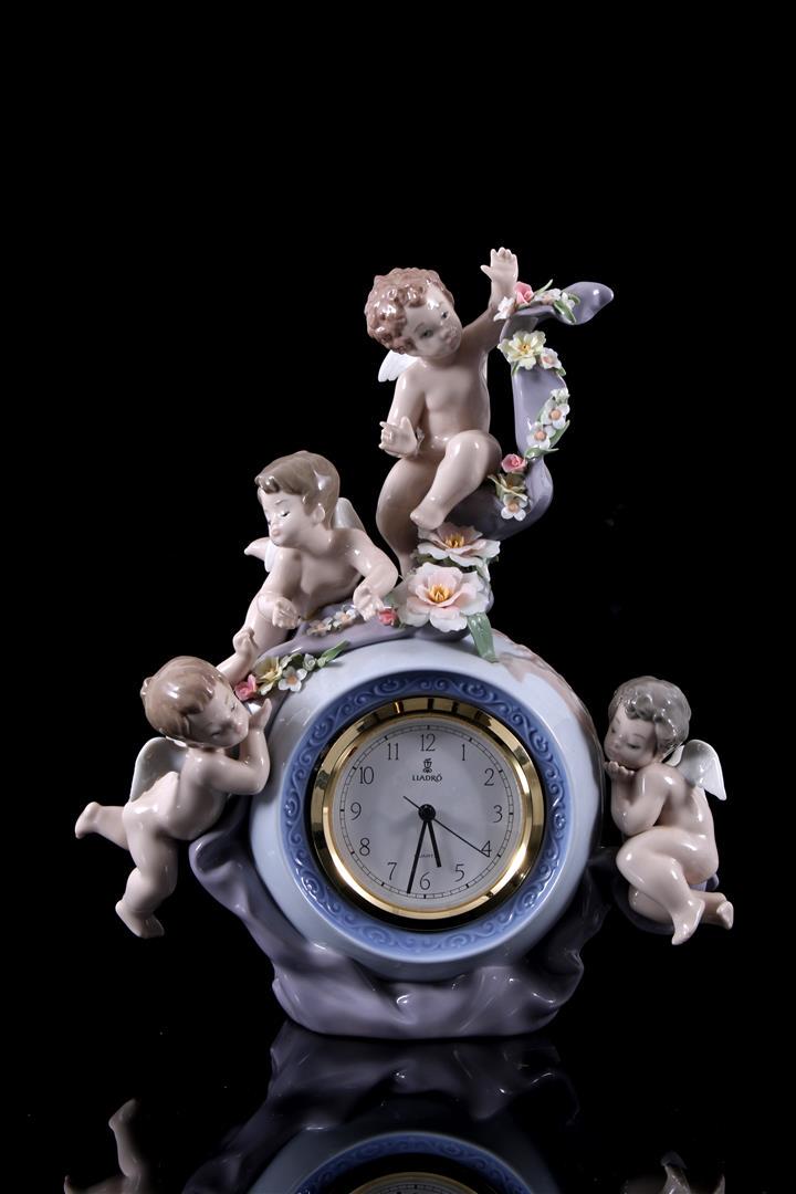 Lladro porcelain statue no.5973, Angellic Time: Lladro porcelain statue no.5973, Angellic Time, Reloj Con Angelitos, design Francisco Polope, period 1993-2006, 30 cm high (1 petal damaged)