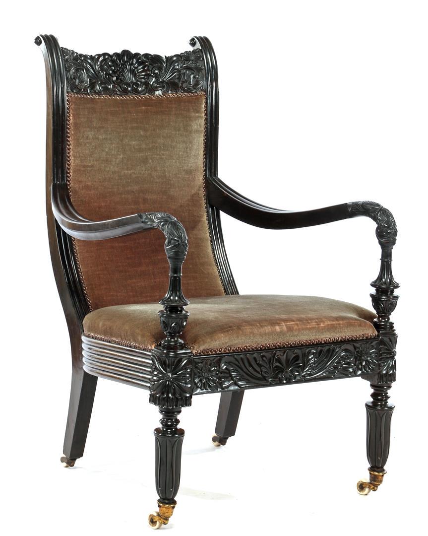 Antique & ebony armchair with beautiful stitching in: Antique & ebony armchair with beautiful stitching in armrests, front and shade, brown upholstered backrest and seat, standing on porcelain wheels, Ceylon / Sri Lanka approx. 1920