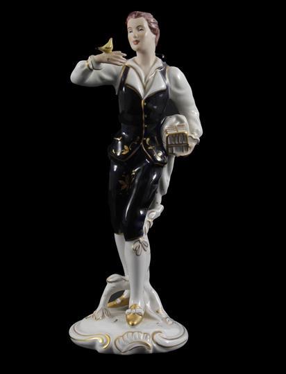 Royal Dux: Royal Dux porcelain statue of a man with a bird on his hand, 30 cm high