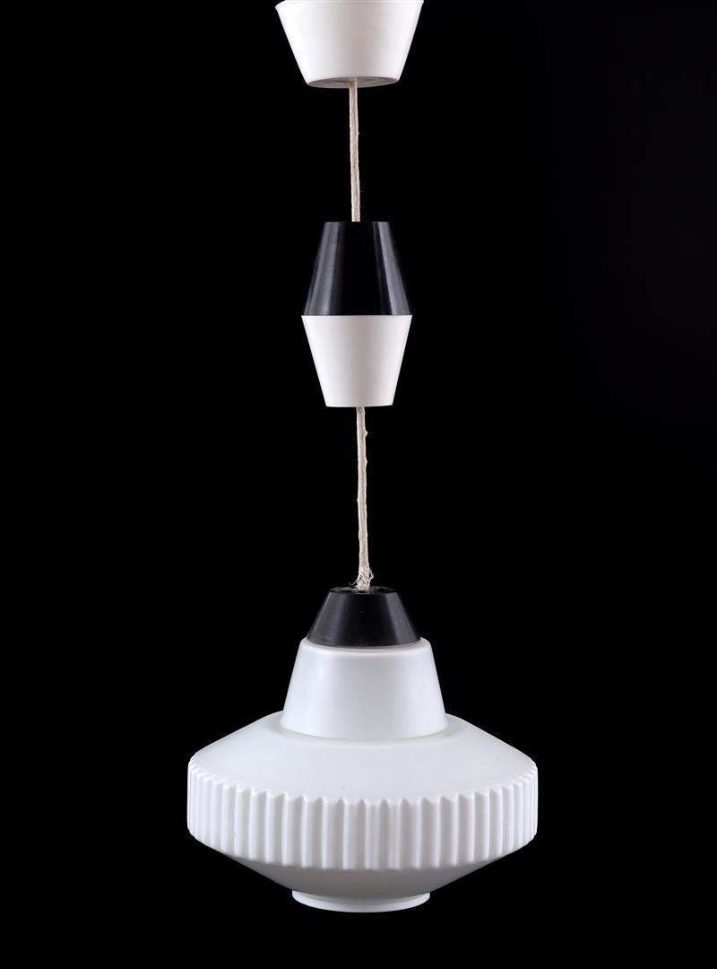 Louis Christiaan Kalff: Louis Christiaan Kalff (1897-1976)Ribbed milk/opaline glass hanging lamp with black plastic accents, design Louis Kalff for Philips, Netherlands 1950s, 60 cm high