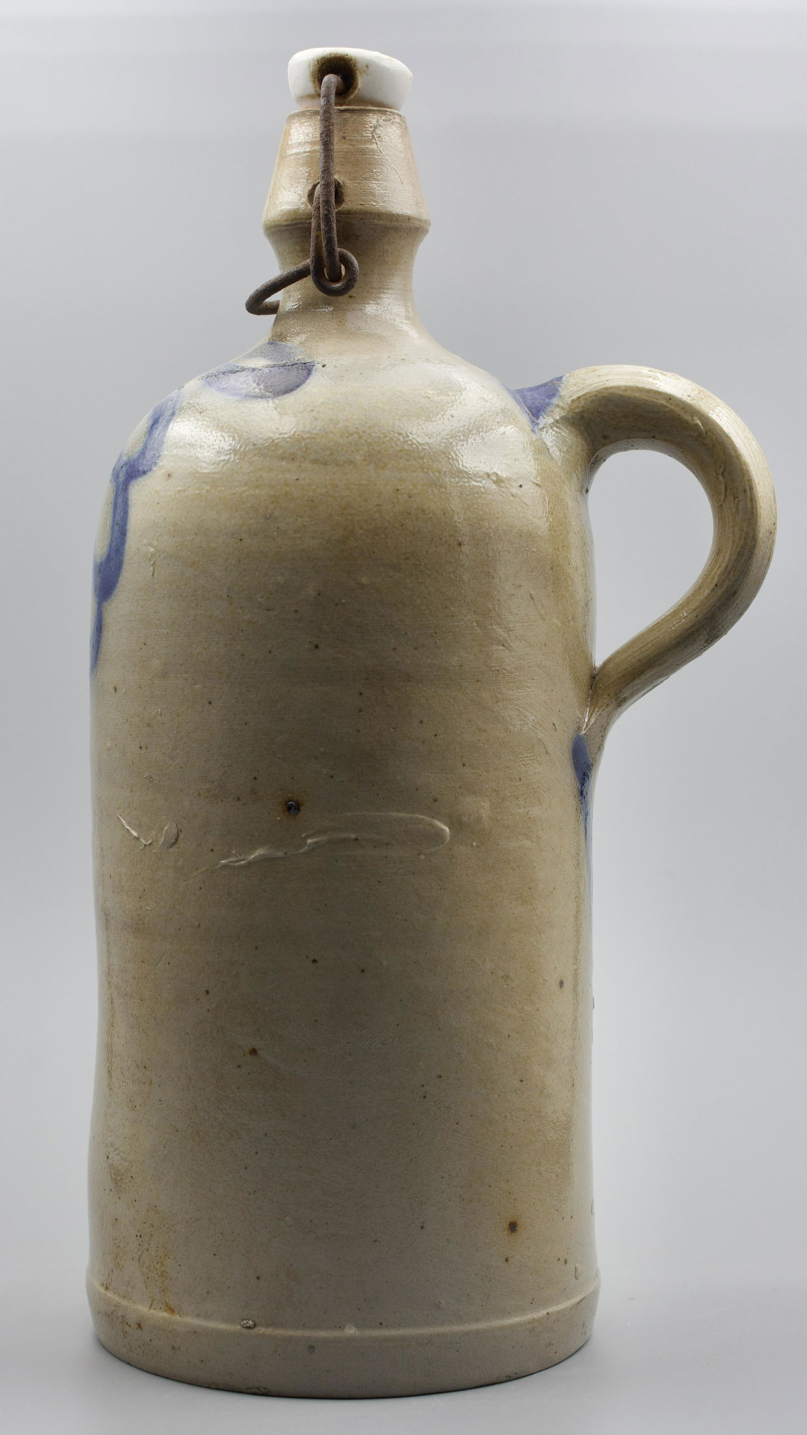 SALT-GLAZED STONEWARE BOTTLE WITH PORCELAIN CAP AND STRAP HANDLE. (1 of 5)