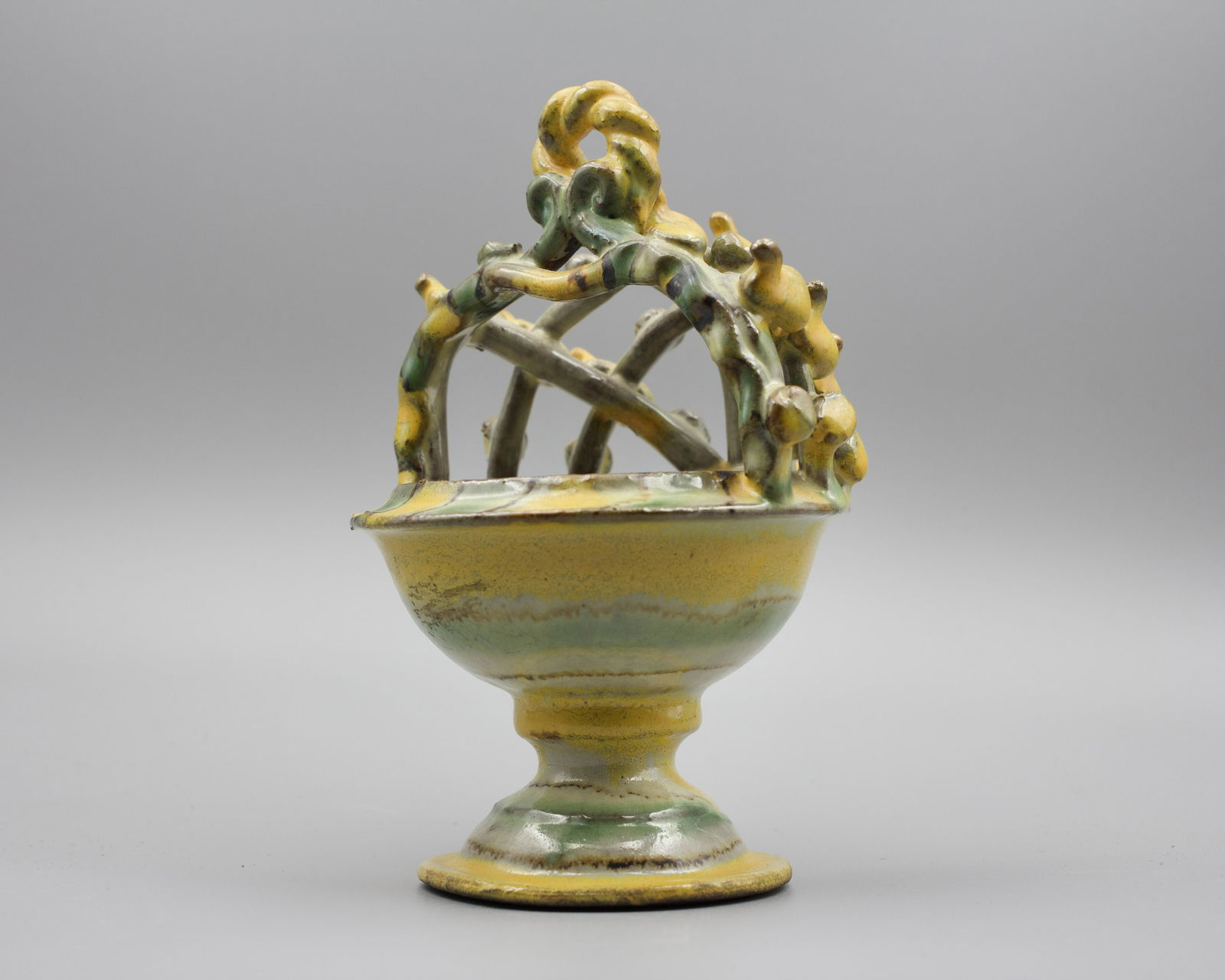 REDWARE SLIP DECORATED MASTER SALT.: Likely Continental, 19th Century. Yellow and green slip decorated open-work basket-form bonnet. Complex construction. 6"h. 4.25"d.