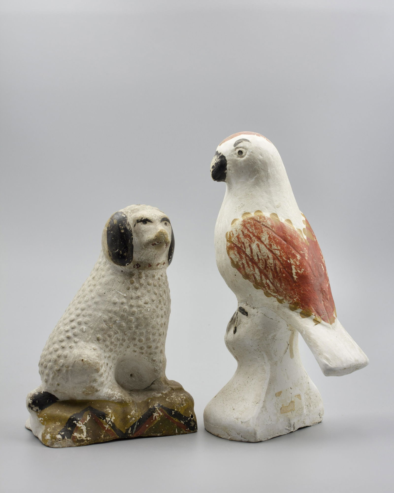 SEATED CHALKWARE DOG AND CHALKWARE PARROT. (1 of 5)