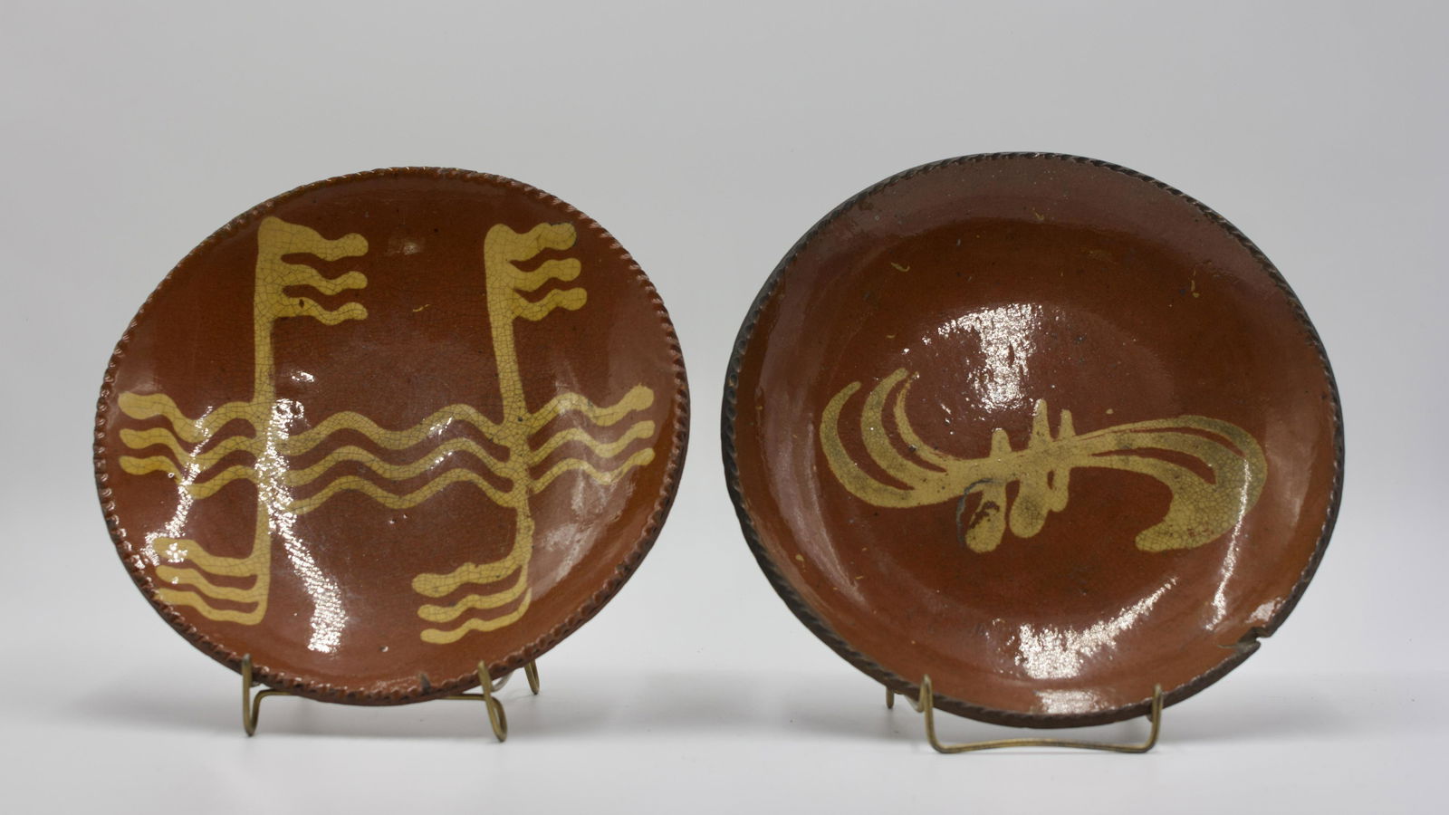 TWO SLIP DECORATED PLATES. (1 of 2)