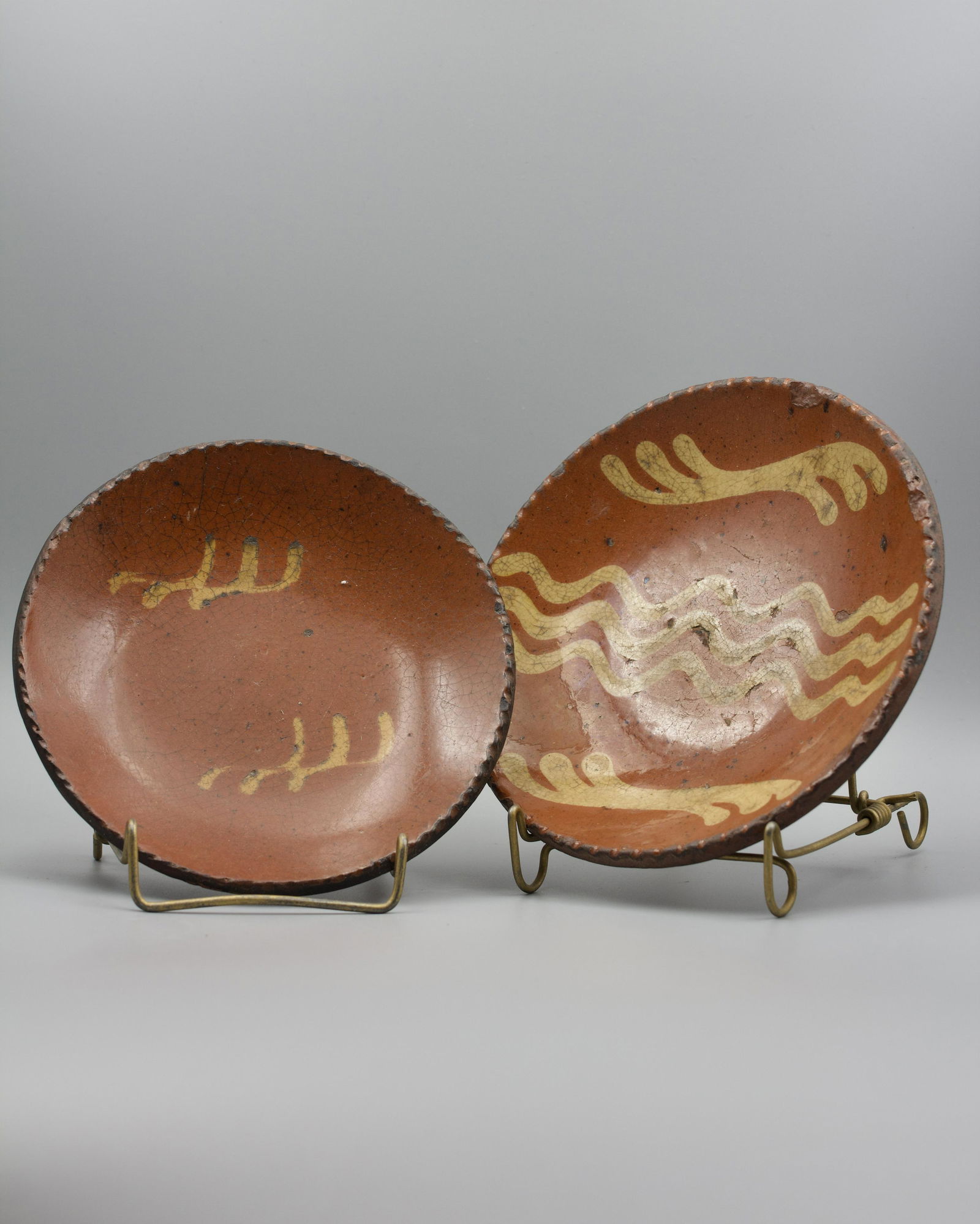 TWO SLIP DECORATED PLATES. (1 of 6)