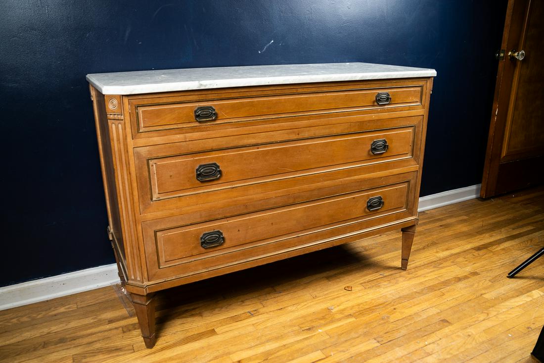 PAIR OF CONTINENTAL CHESTS WITH MARBLE TOPS.: European. Chamfered corners with reeding, shaped marble tops, dovetail construction, metal pull handles. Good condition, wear consistent with age. 49"w x 29.25"d x 34.5"h measurement of one.