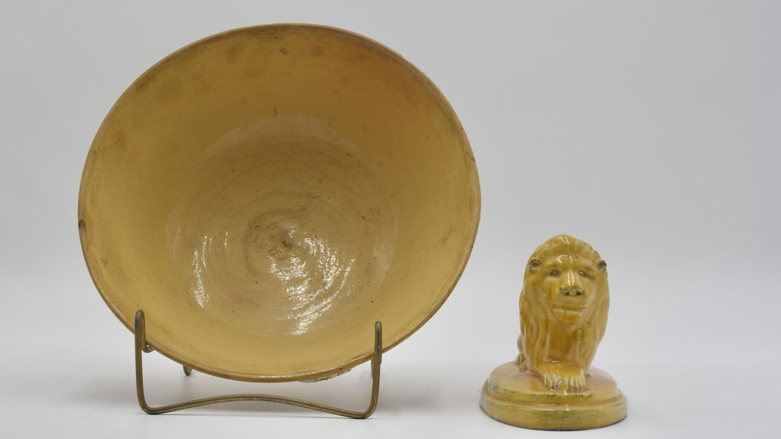 YELLOWARE LION AND BOWL WITH ROSSETTES.: American, 19th Century. White applied rosettes on bowl. Lion, 5.75"h. Bowl, 4.5"h. Condition: Bowl has small chip to rim. Lion has chip to base.