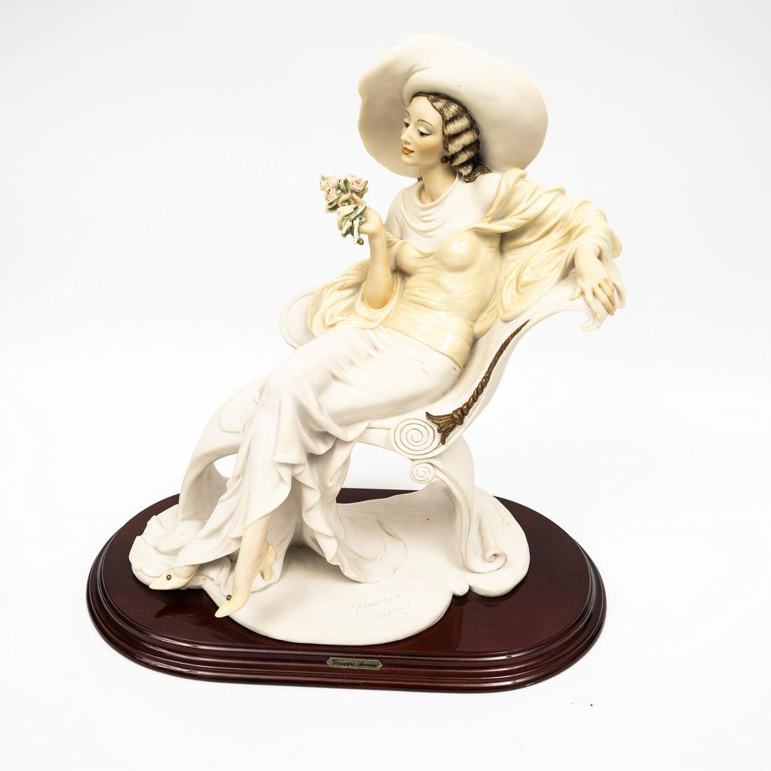 "AT EASE" PORCELAIN FIGURINE BY GIUSSEPPE ARMANI (1993-2006).: Italy, 1994. Capodimonte porcelain figurine titled "At Ease" by Giuseppe Armani for Florence Scultur D'Art. Signed in the mold and marked with the blue crown capodimonte mark. Excellent condition. 14"