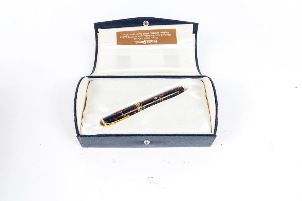 STAINLESS STEEL AND TITANIUM FOUNTAIN PEN BY PORSCHE DESIGN FOR FABER CASTELL.: Germany, 21st Century. Braided metal barrel with smooth cap and 18k gold nib. Gently-used condition with scuffing to end of barrel. Approx. 5.75"l.
