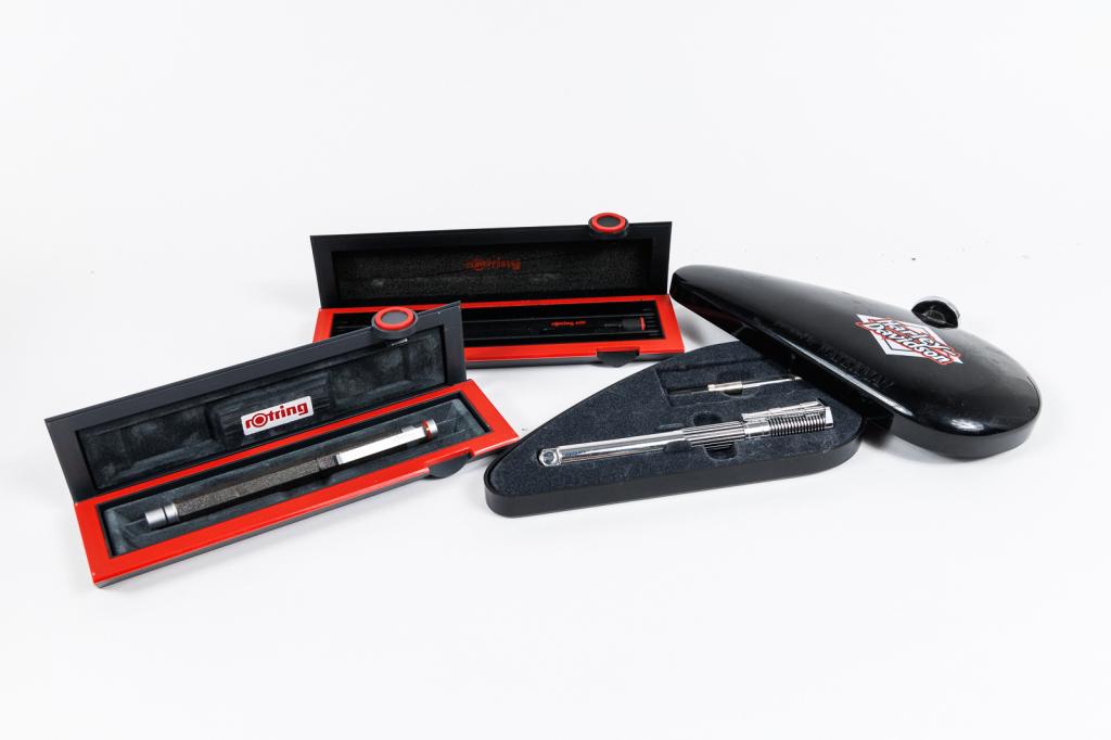 THREE VINTAGE FOUNTAIN PENS.: France and Japan, 21st Century. A "Harley Davidson Powered by" Waterman pen with original box; a Rotring 600 with "B" nib; and a Rotring graphite barrel and cap with an "F" nib. Each roughly 5.5"l. Ve