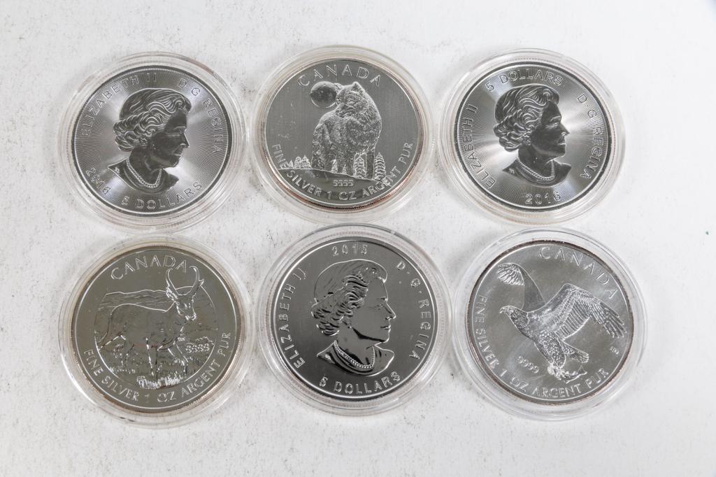 GROUP OF CANADIAN FIVE DOLLAR COINS.: Canadian, 21st Century. One 2011 Canadian Silver Wolf $5 coin in case; One 2013 Canadian Silver Pronghorn Antelope $5 coin in case; One 2014 Uncirculated Canadian Silver Bald Eagle $5 coin in case; On