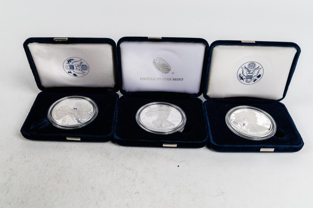 GROUP OF AMERICAN COIN SETS.: American, 21st Century. One 2003 American Eagle One Ounce Silver Proof Coin in original packaging; One 2015 American Eagle One Ounce Silver Proof Coin in original packaging; One 2010-W American Eagle