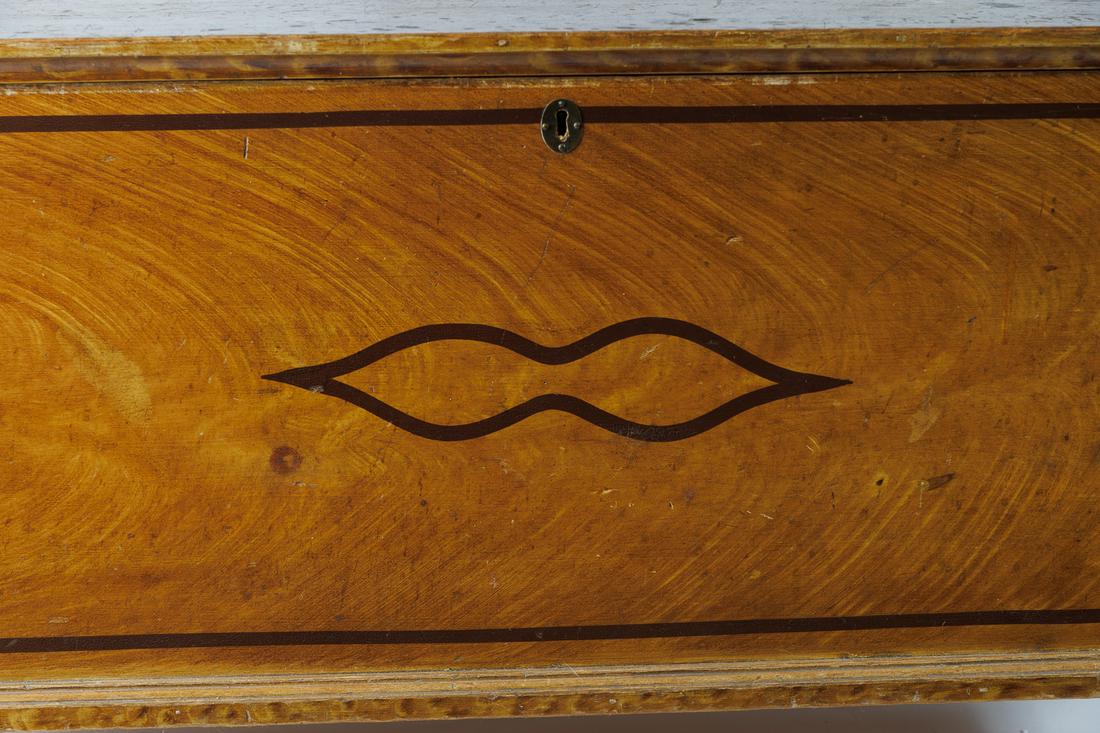 DECORATED BLANKET BOX.: American (Ohio), 19th Century. Black banded decoration over mustard and brown decorated base on turned feet. 24"h x 18"d x 44"w.