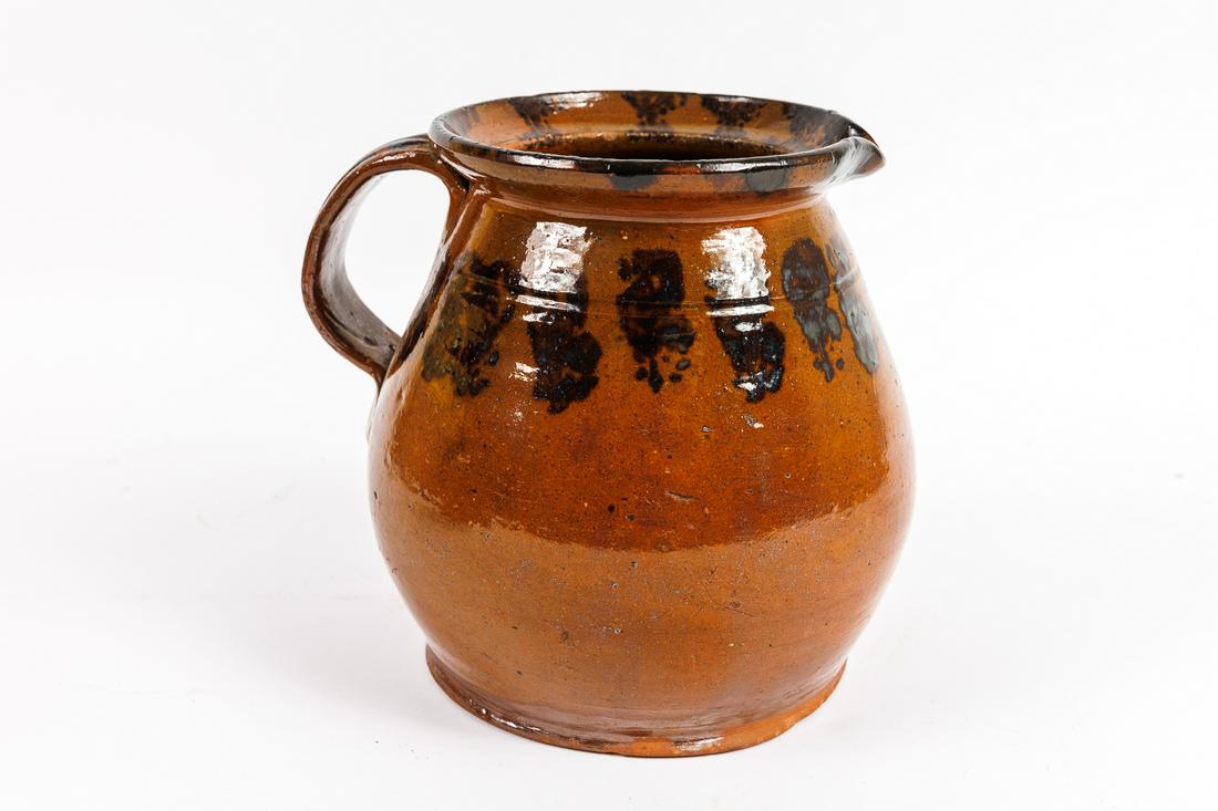 BATTER JUG.: American, 19th Century. Red ware Manganese decorated batter jug. 8.25"h.