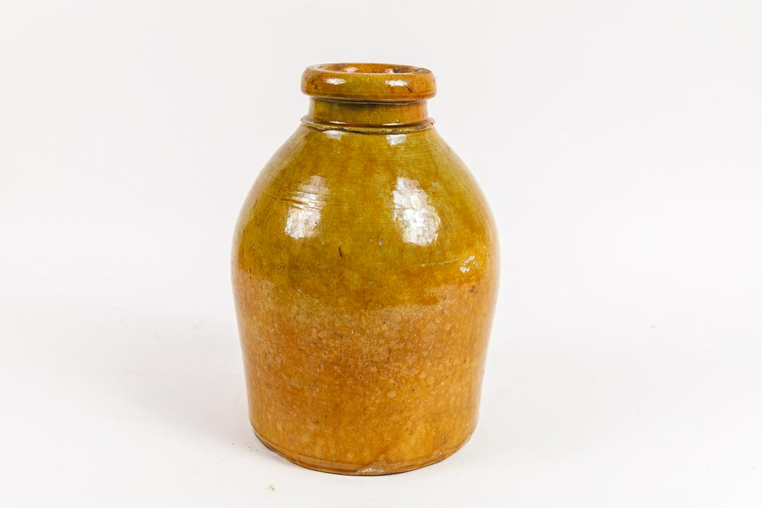 REDWARE JAR.: American, first half 19th Century. N.E. Origin red ware jar with a yellow and orange glaze. 11"h.