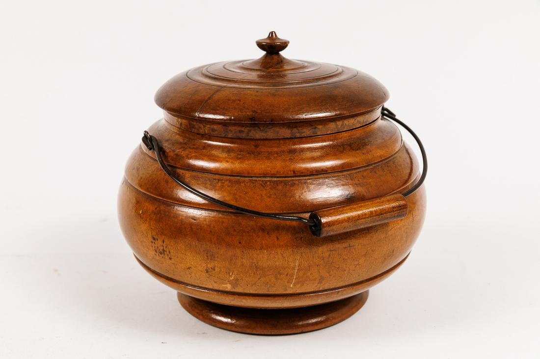 PEASEWARE COVERED CANISTER WITH HANDLE.: American, 19th Century. Lathe turned wooden jar with bail handle. Old crack on top of lid. 6.75"d. 6.75"h.