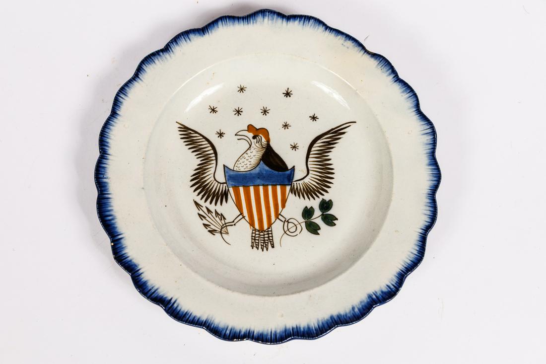 DECORATED PEARLWARE PLATE.: English, 19th Century. Eagle in center with blue shell-edge. Also referred to as soft paste porcelain, Leeds, feather-edge. 6 .25''. Fine condition.