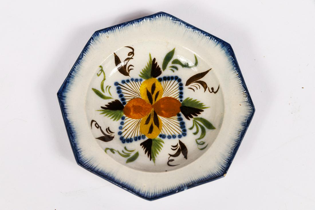 MINIATURE DECORATED PEARLWARE PLATE.: English, 19th Century. Octagonal with flower sprig, blue shell-edge border. Also referred to as soft paste porcelain, leeds, feather-edge. 4''. Ex Greg Kramer.