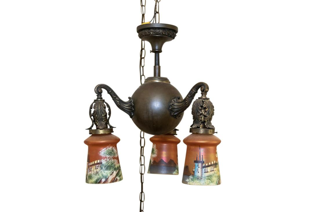 HANGING LAMP BY BRADLEY AND HUBBARD.: American, 20th Century. Cast iron with brass finish. Three-arm chandelier with acanthus-leaf decoration and hand-painted shades.