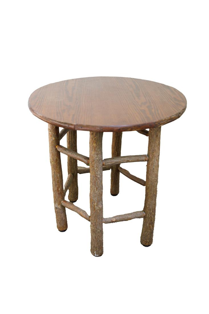 ROUND PRIMITIVE TABLE IN THE MANNER OF OLD HICKORY FURNITURE.: American, 20th Century. Primitive round top table with log legs. 30.5"h. 30.25"d.