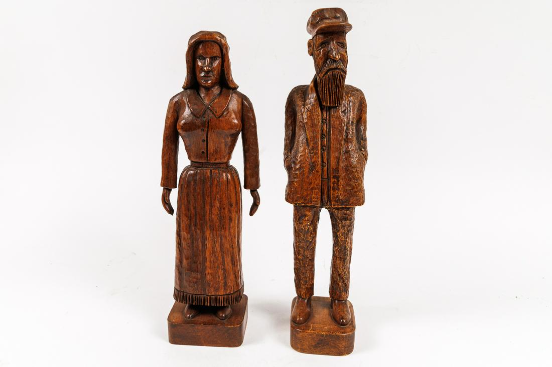 PAIR OF FULL LENGTH FOLK ART WOOD CARVED FIGURES BY CLARENCE STRINGFIELD (TENNESSEE, 1903 - 1976).: American, 20th Century. Each signed in blue ink on underside of base. Woman with bonnet, skirt, and hands by her side. 14.5"h. Man with beard, cap, and jacket with hands in pockets. 15.5"h.