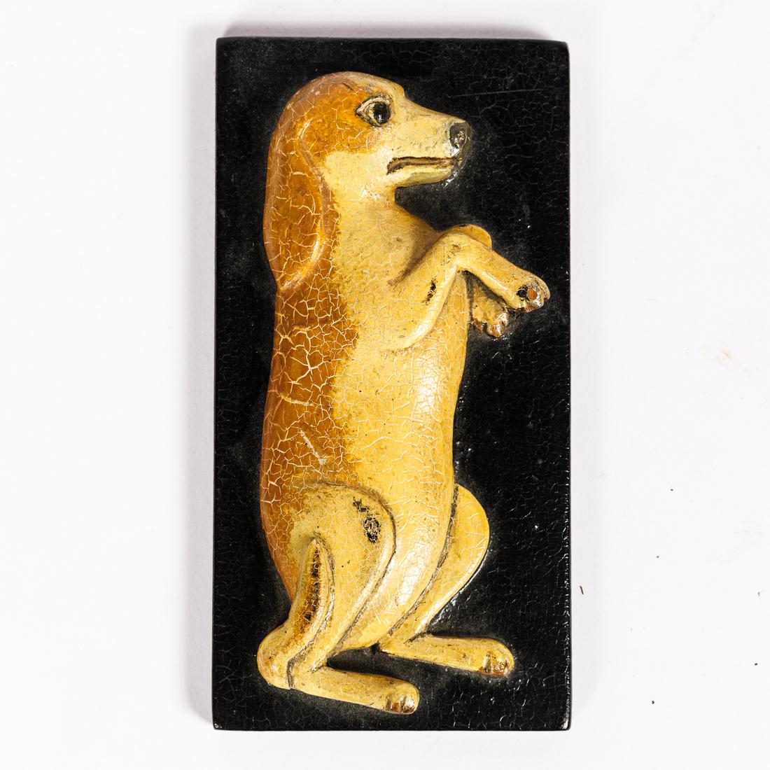 FOLK ART WOOD CARVED DOG PLAQUE.: American (Minnesota), mid-20th Century. Carved by Emil Rishavy, St Paul 1911. 2.75"w. 5.25"h. Ex Greg Kramer.