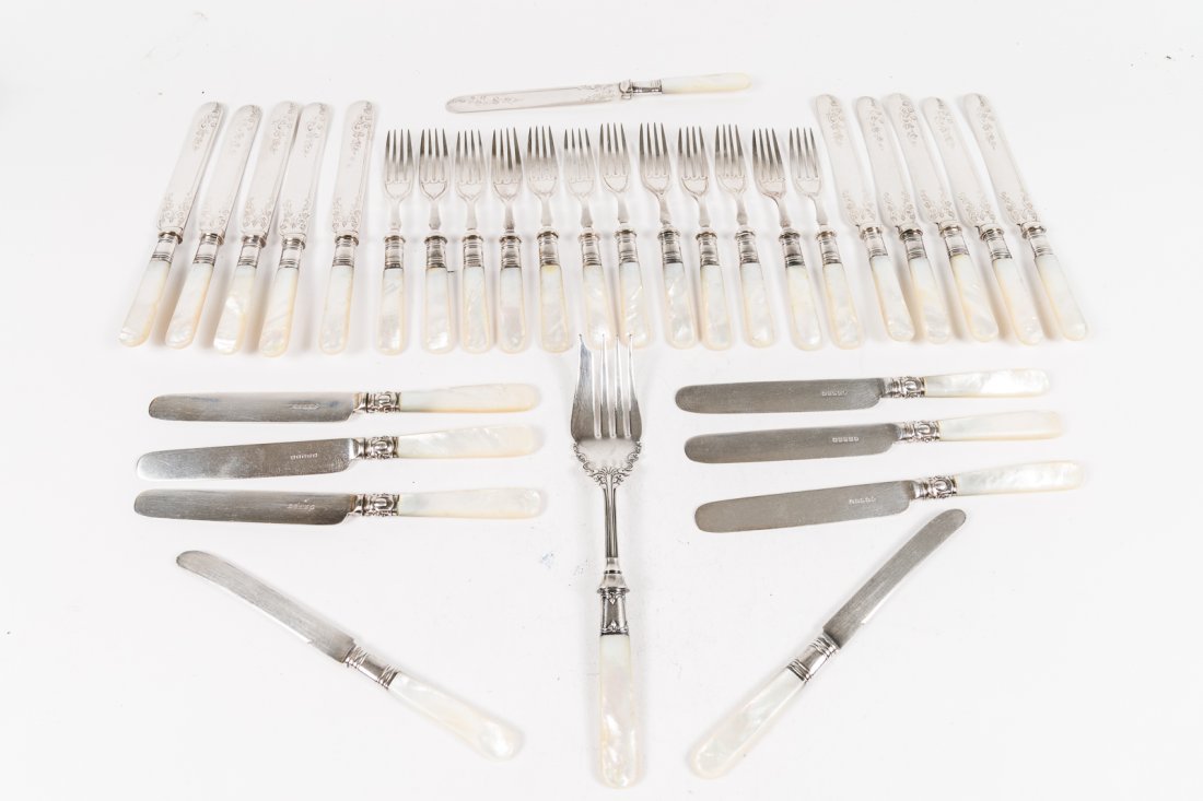 GROUP OF FLATWARE.: American, late 19th-early 20th Century. Group includes nineteen knives, twelve forks and one serving fork, all with mother-of-pearl handles and Sterling bands.