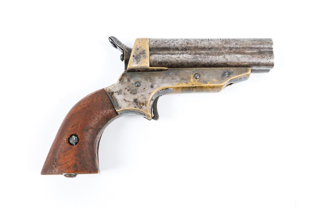 SHARPS MODEL 1 RIMFIRE 4-SHOT PEPPERBOX POCKET PISTOL.: American, 19th Century. Stamped to sides of frame "C SHARPS PATENT 1859" and "C SHARPS & CO PHILADA PA" and at butt serial number 79. Brass frame, steel barrel, .22 caliber, and replaced walnut grips.