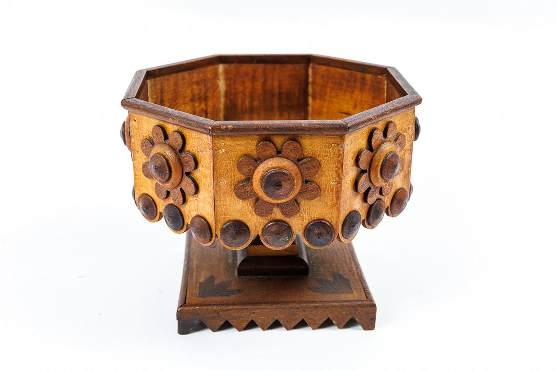 FOLK (TRAMP) ART WOOD COMPOTE.: American, 19th - 20th Century. Unusual form and design with sawtooth base, square stepped stem, applied orbs and flowers. 7"h. Ex Pat Cobb.The interior measures 7.75" across and 2.75" deep.