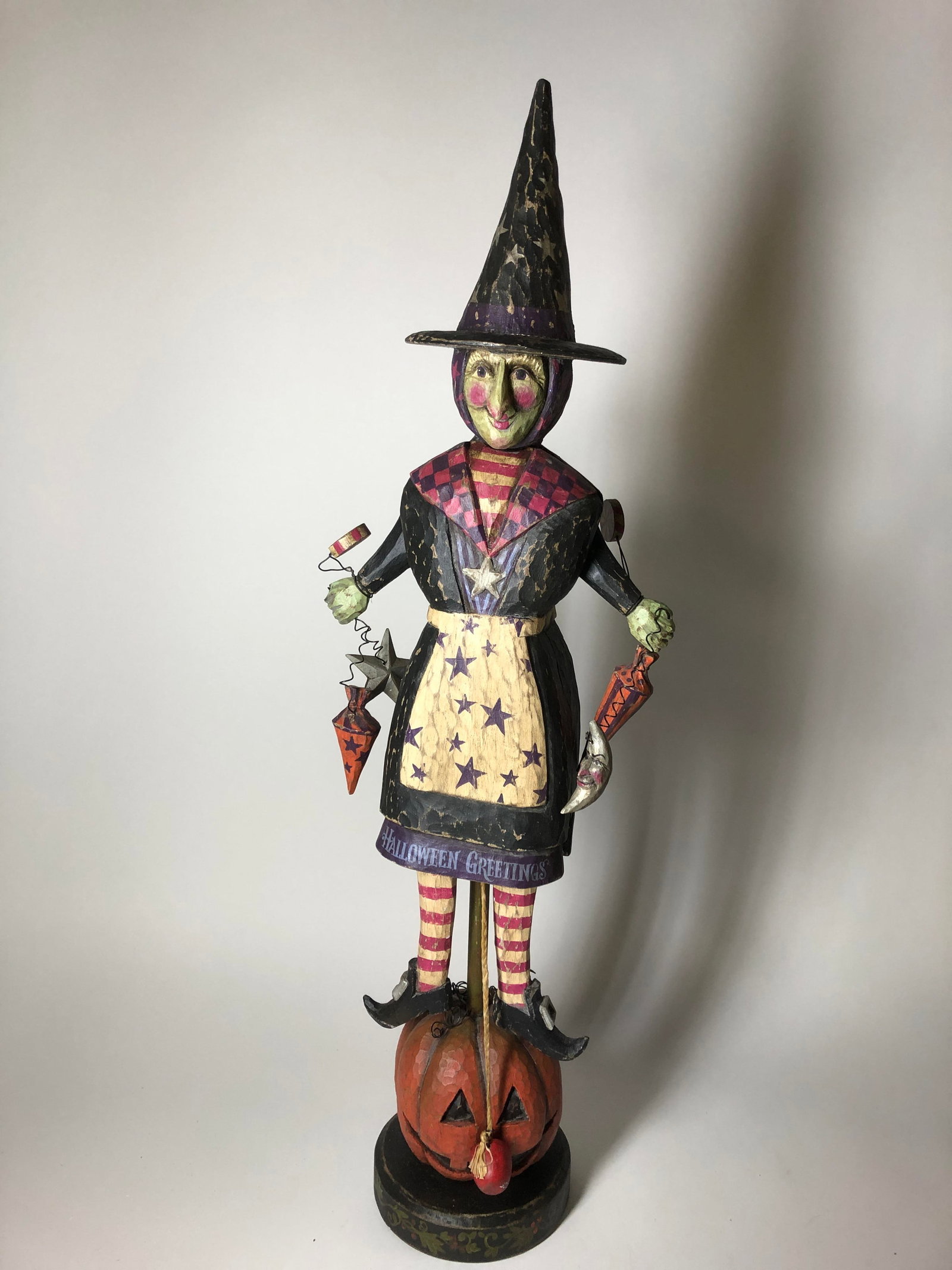 FOLK ART HALLOWEEN-THEMED CARVED AND PAINTED FIGURE BY P. SCHIFFERL.: FOLK ART HALLOWEEN-THEMED CARVED AND PAINTED FIGURE BY P. SCHIFFERL. American, 20th - 21st Century. Wood, paint, metal, and textile. Full-bodied Halloween witch with hinged arms and legs mounted on po
