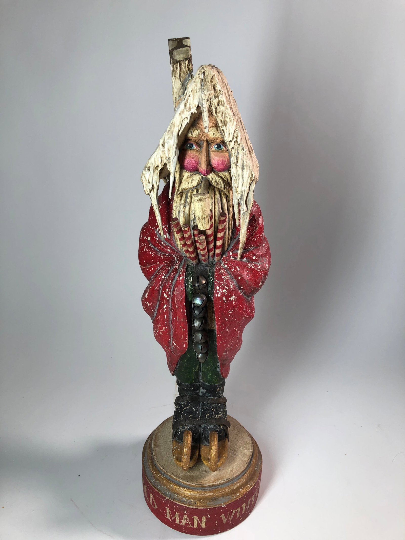 FOLK ART WINTER-THEMED CARVED AND PAINTED FIGURINE BY P. SCHIFFERL.: FOLK ART WINTER-THEMED CARVED AND PAINTED FIGURINE BY P. SCHIFFERL. American, 20th - 21st Century. Wood, paint, metal, and textile. Full-bodied winter-themed figure on skates carrying striped sticks a