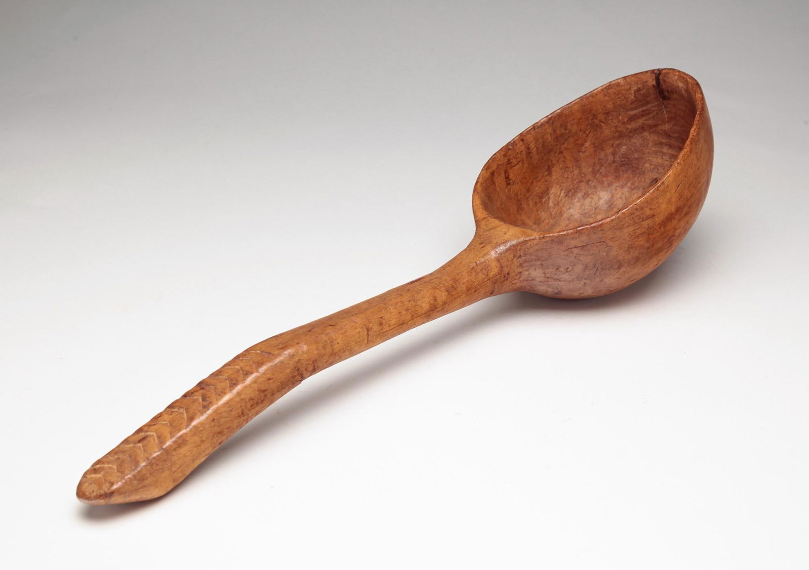 LARGE CARVED TREENWARE SPOON. (1 of 3)