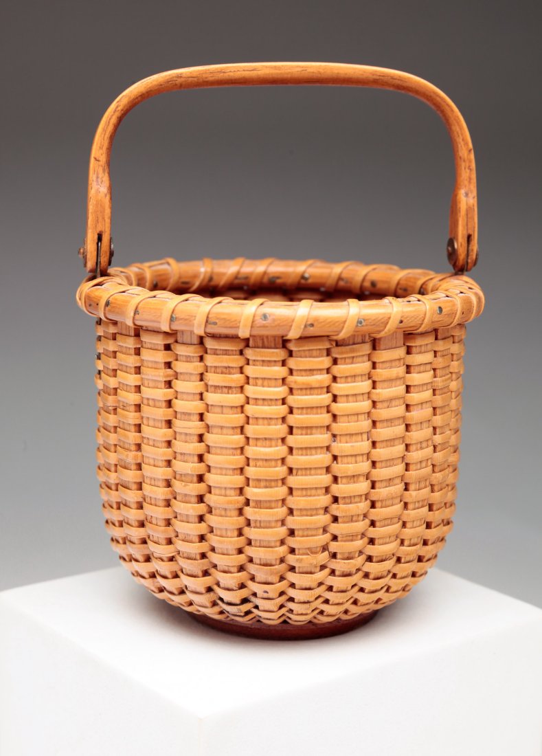NANTUCKET BASKET BY STEPHEN GIBBS (1896-1974).: American, 20th Century. Basket with attached handle. Marked "S. Gibbs Maker Nantucket, MA". 5"h. 3.5"d.