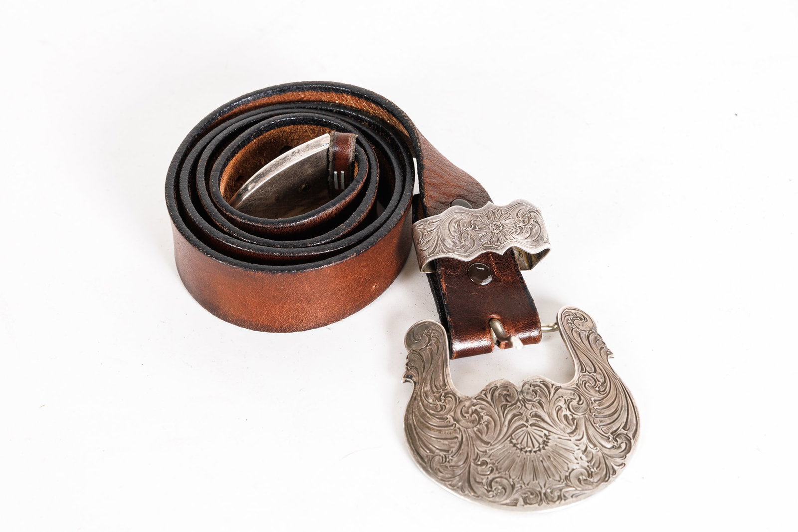 LEATHER BELT WITH SILVER BELT BUCKLE.: American, 20th Century. Belt stamped "Robinson USA". Size 34. 43"l.