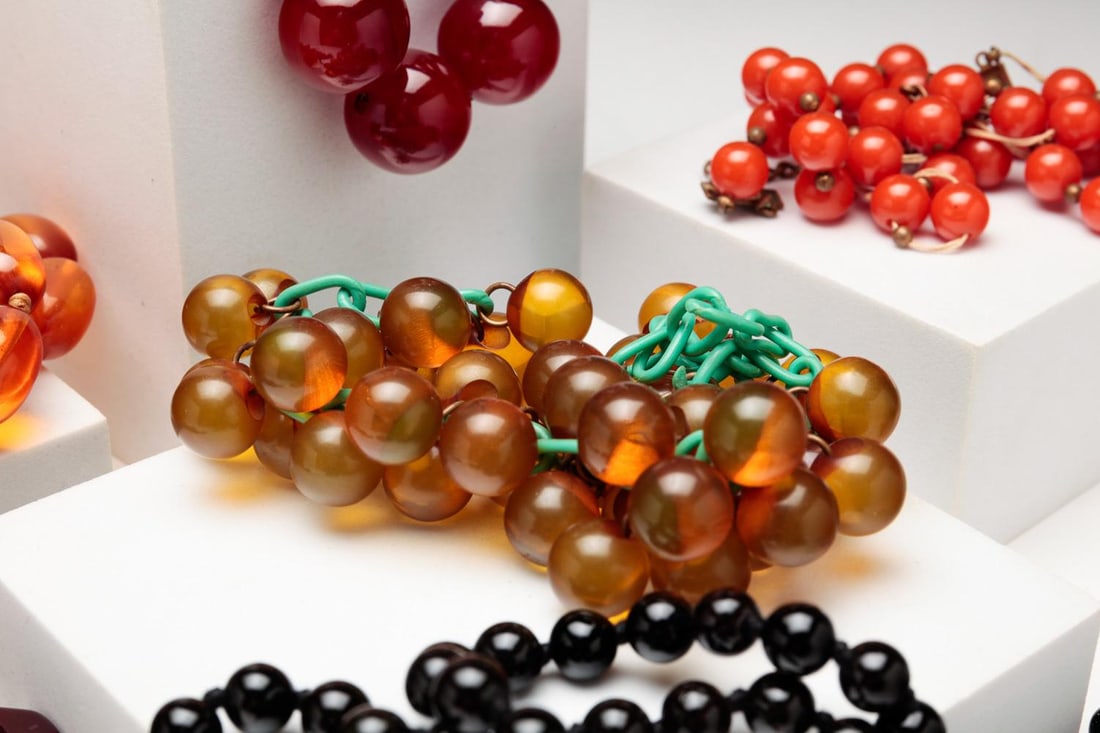 NINE STRANDS BAKELITE AND OTHER BEADS.: American, mid-20th century. Nine strands beads of various lengths, colors and sizes, five bakelite. Lengths range from 16" - 30.5", one strand needs to be restrung (round orange beads).