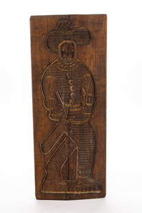 WOOD COOKIE BOARD.: Continental, 20th Century. Carved with a full-length figure of a man with a hat. 28"l. 11"w. 1"d.