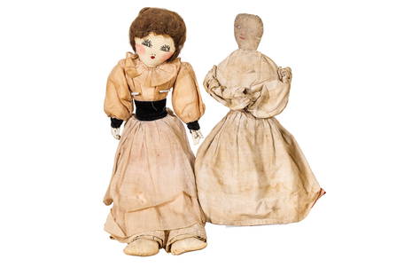 TWO FOLK ART DOLLS.: American, late-19th Century. One topsy-turvy doll. One Victorian doll with pottery hands, and real hair. Some wear.