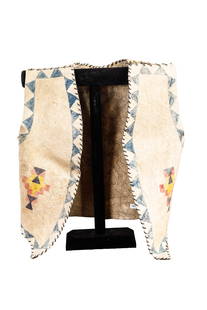 NATIVE AMERICAN CHILD'S VEST.: American, late 19th Century. Hand-dyed and decorated hide. 16"h. 17"w.