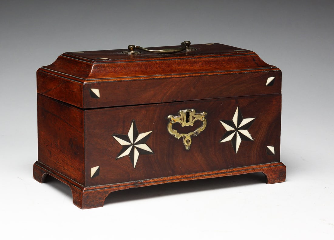 AMERICAN INLAID TEA CADDY.: America, first quarter 19th Century, mahogany veneer. Possibly sailor related with bone and baleen inlays. Molded edge lid, bracket feet, and brass escutcheon and bail handle. Interior tin compartment