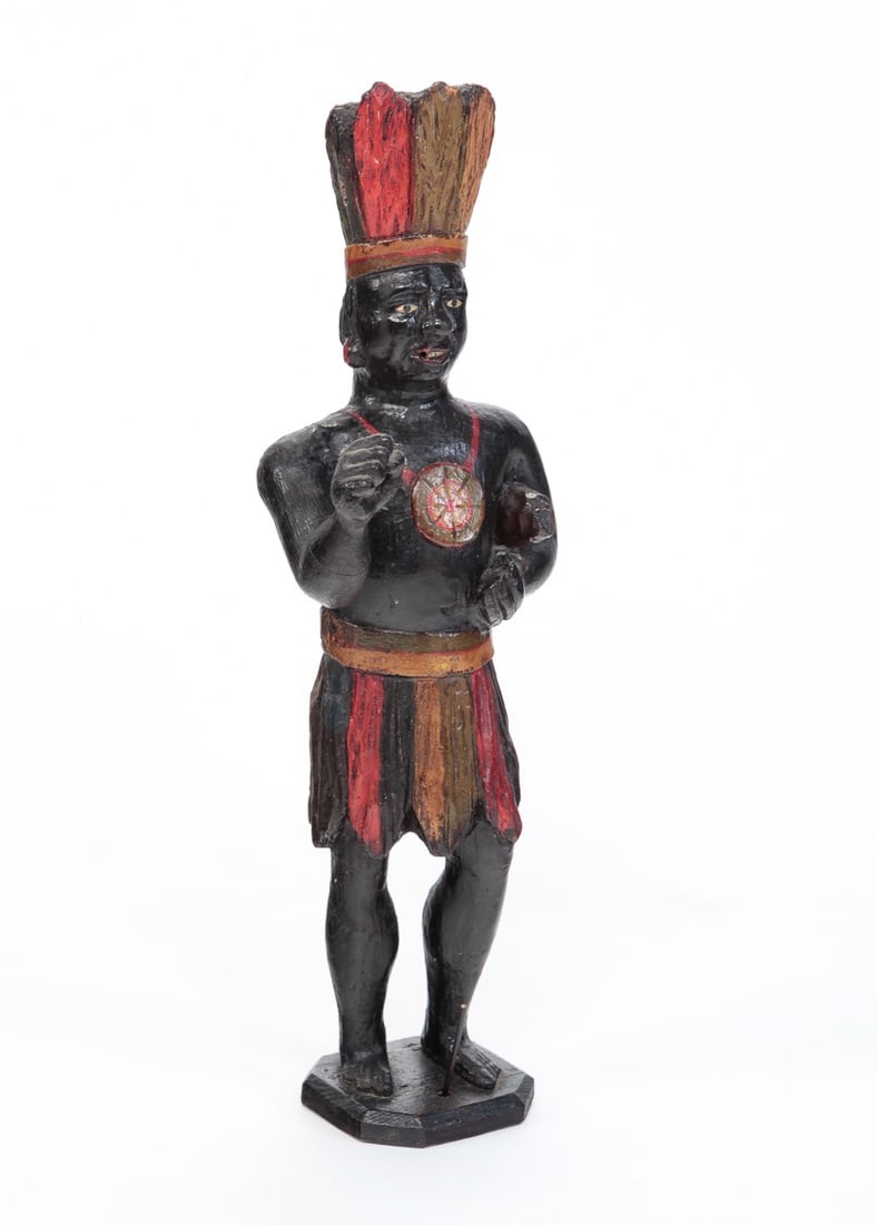 AMERICAN STORE COUNTER CIGAR STORE INDIAN.: America, late 19th Century. Pine. Standing figure with thick polychrome paint and some overpaint. Varnished surface. Minor flakes, holes in hand and mouth for missing objects, partial stick on base. 2