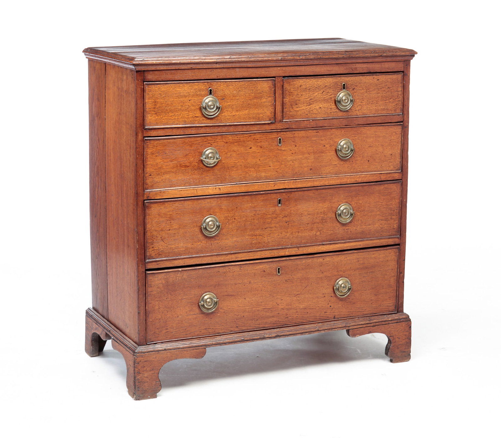 CHIPPENDALE CHEST.: England, Late 18th Century. Oak with pine secondary. Top with applied edge moldings, two over three dovetailed drawers with applied beaded edges and bracket feet. Refinished, replaced brasses and age 